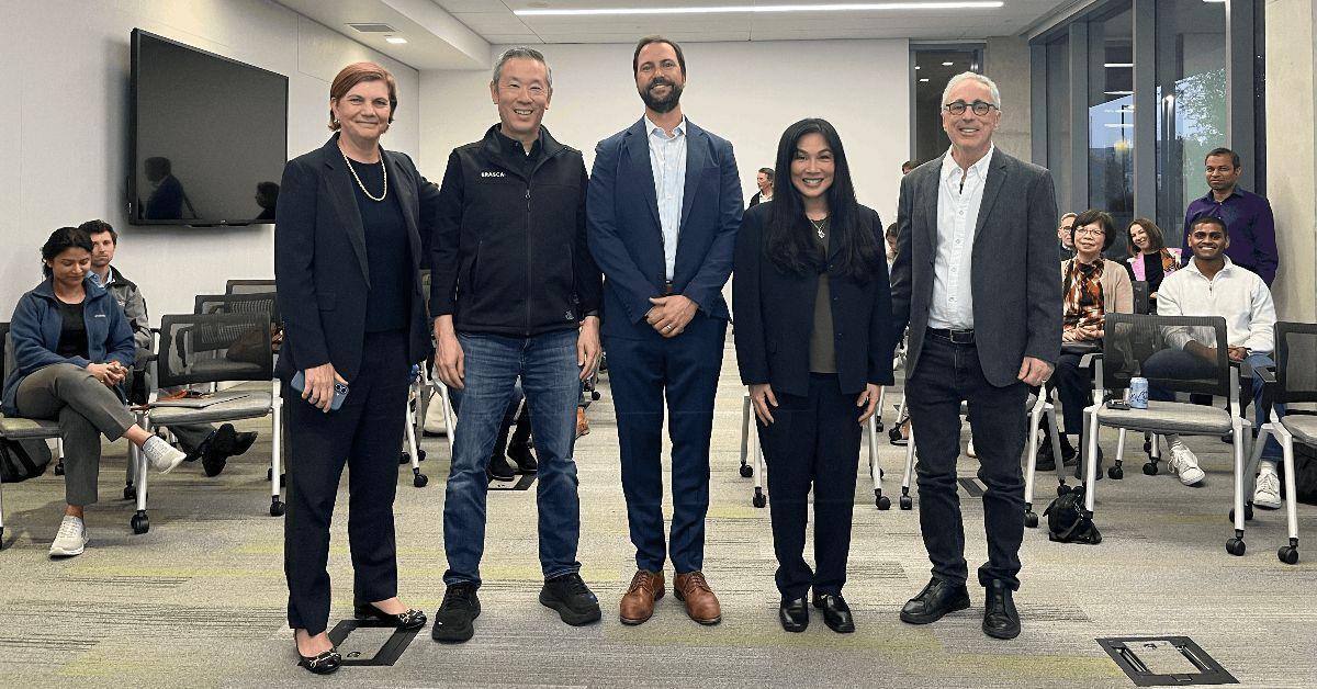 group photo of people holding a check
